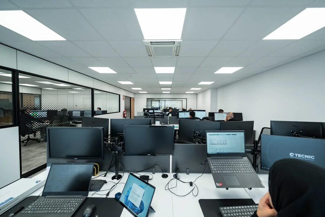 person-in-blue-long-sleeve-shirt-sitting-beside-black-laptop-computer-9gpkrsbgmc